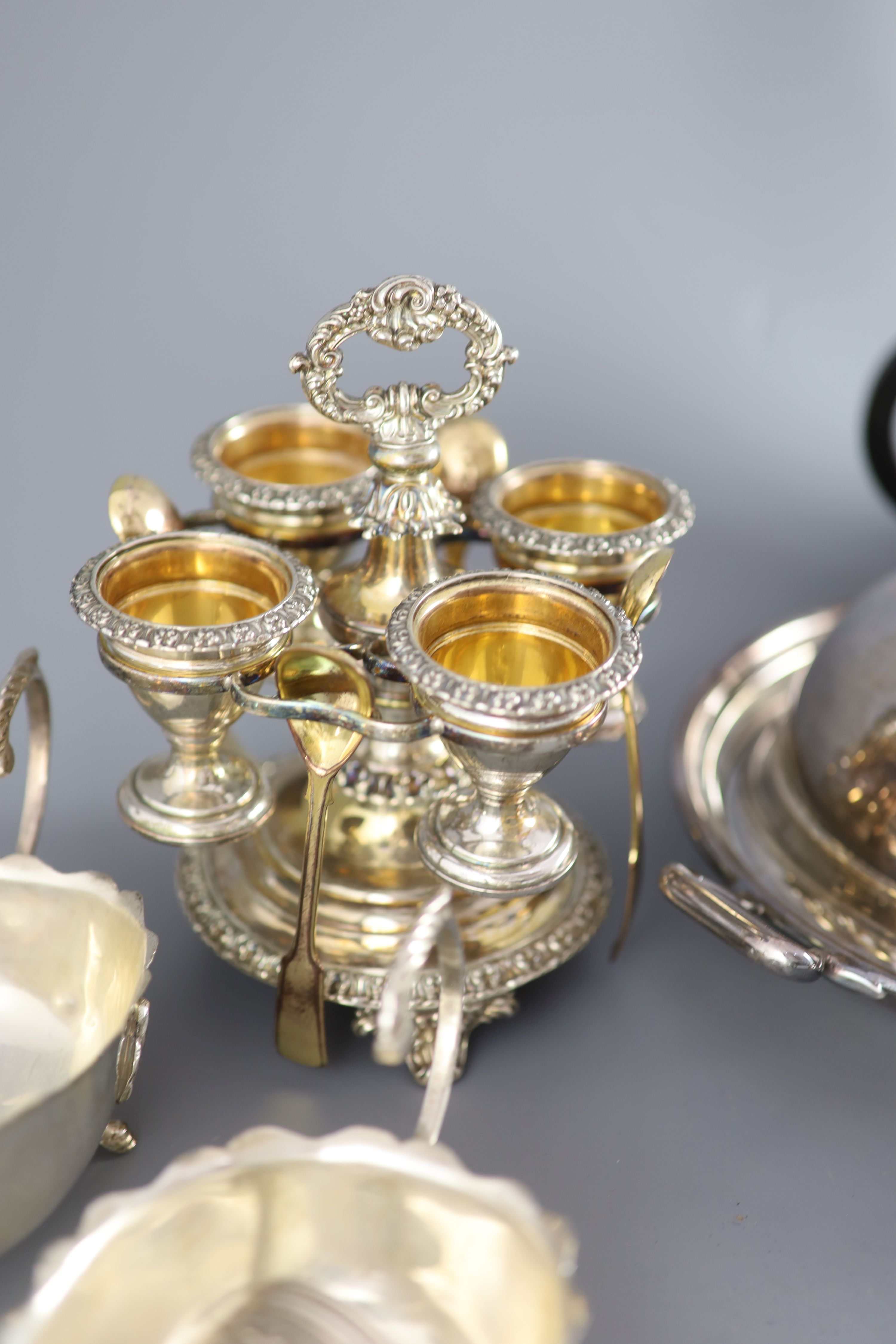 A silver plated egg cruet, a butter dish, a table salt and sundry other plated wares